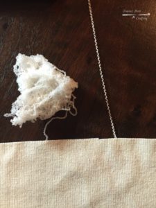 Unraveling the silk and discarding the nylon from a mixed-fiber sweater