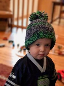Benjamin wearing his Seahawks crochet hat: color twisting beanie