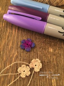 Crochet flowers colored with purple, lavender, and periwinkle Sharpies