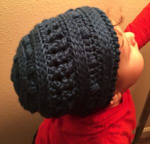 Our 2-year-old wearing the winter picnic hat