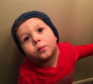 Benjamin is learning to model textured crochet hats