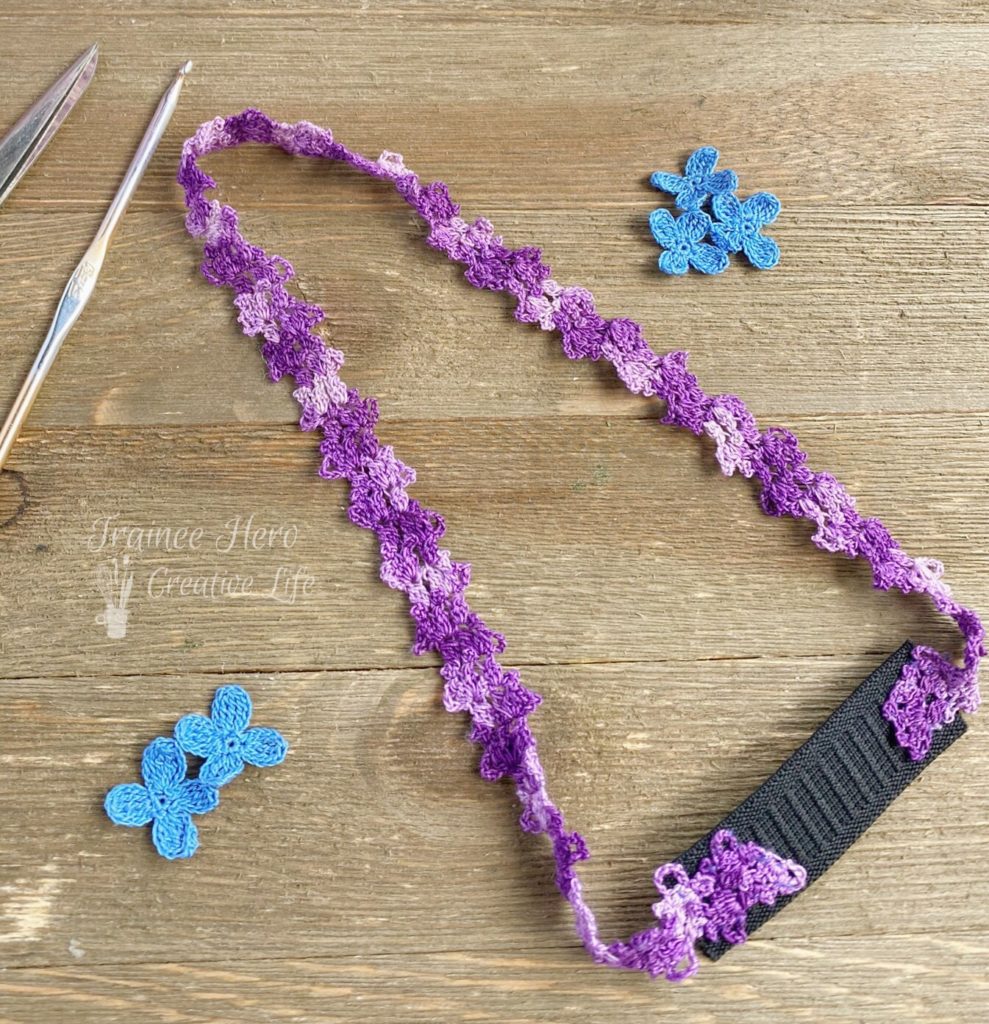 Purple crochet headband made from a crochet edging pattern