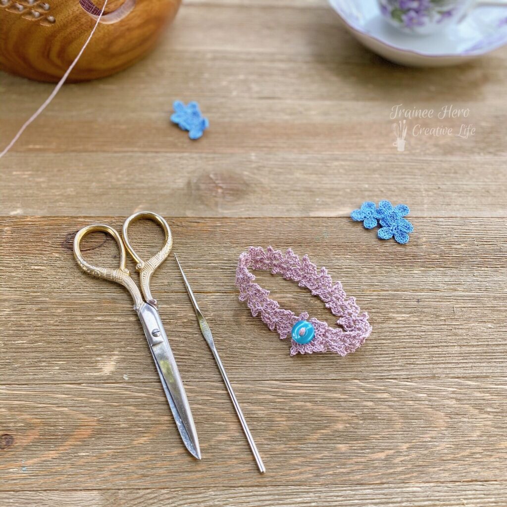 One crocheted bracelet fastened with a button in a circle.