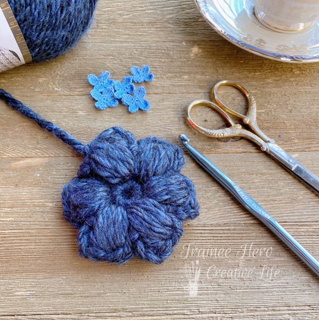 A chunky crochet puff stitch flower.