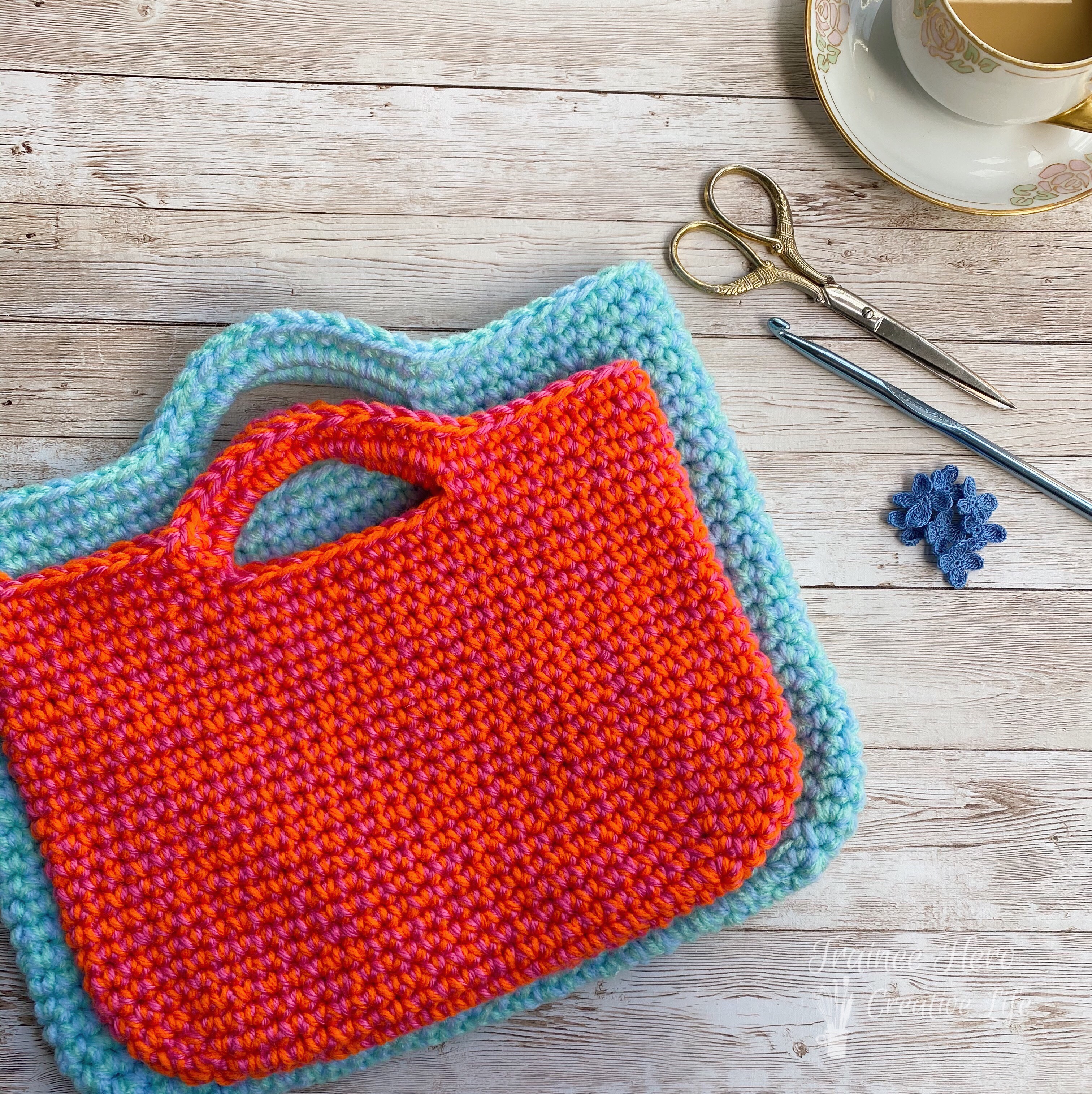 Two crocheted bags stacked one on top of the other.